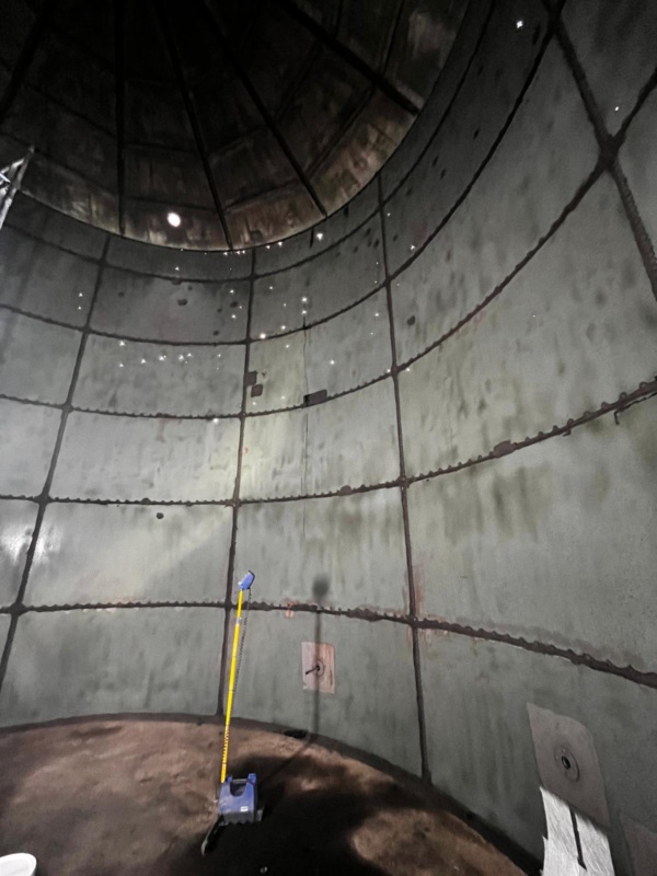 Steel tank is sandblasted in preparation for GRP lining, showing leakage holes above the water line