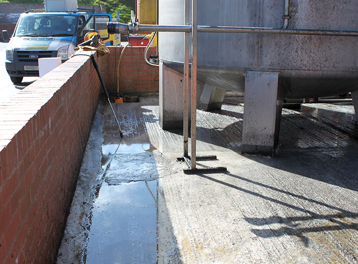 Rapeseed oil had leaked into the bund. Special caustic cleaners were used, then grit blasting in preparation for matting.